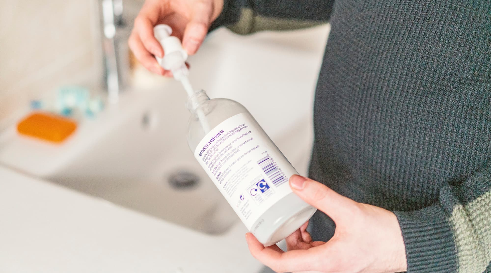 Pump being removed from clear plastic handwash bottle