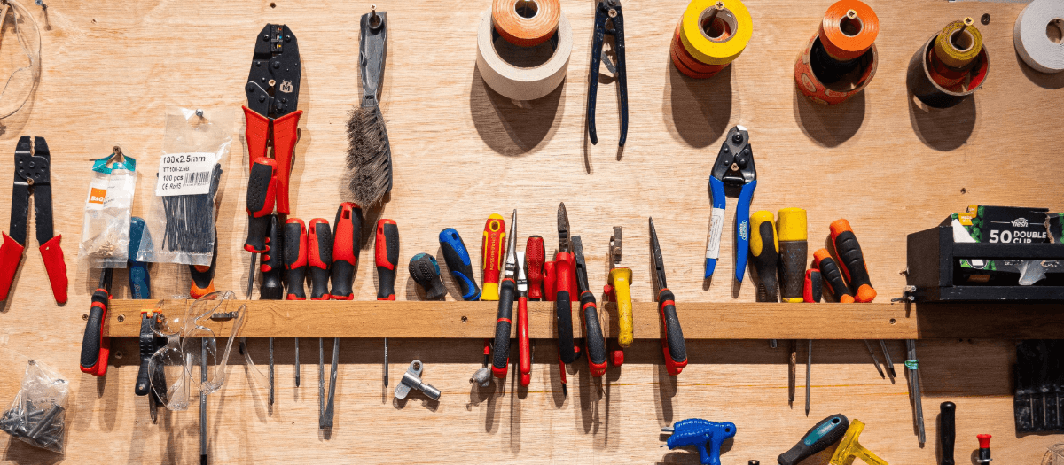 a wall with a variety of colourful repair tools