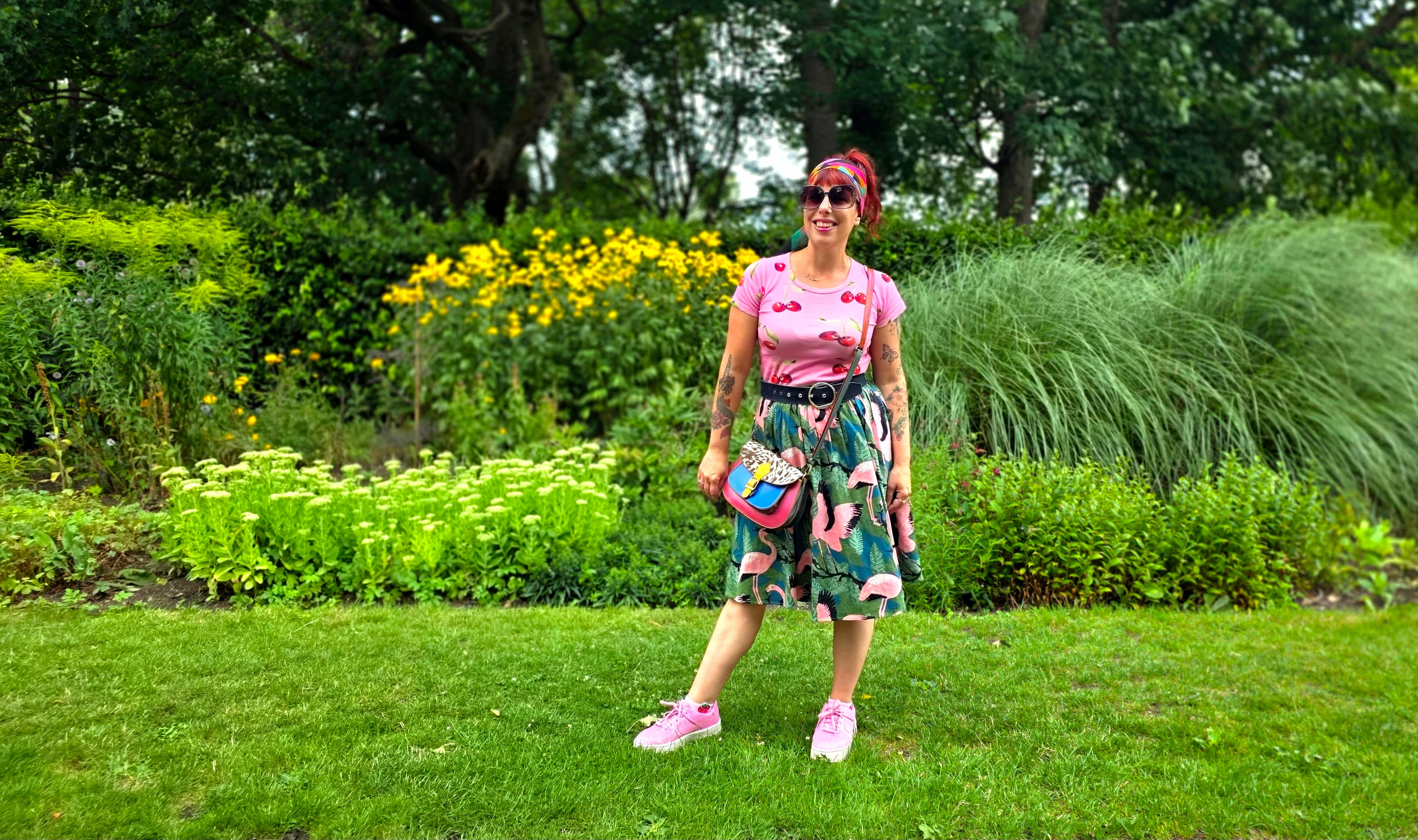 A photo of Ange in bright clothes standing in nature